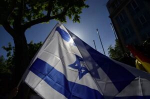 A person waves an Israeli flag during a Pro-Israel demonstration in front of the Israeli Embassy in Madrid, on May 20, 2021. JAVIER SORIANO / AFP/GETTY IMAGES