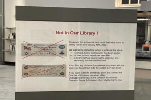 Library staff posted a sign condemning the racist, antisemitic flyers found in the shelves of the 1933-1945 German history section. (Photo courtesy of Jonathan Miller.)