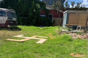 The son of a Holocaust survivor was appalled to discover a makeshift wooden swastika in the backyard of a Melbourne property in the heart of the city's Jewish community