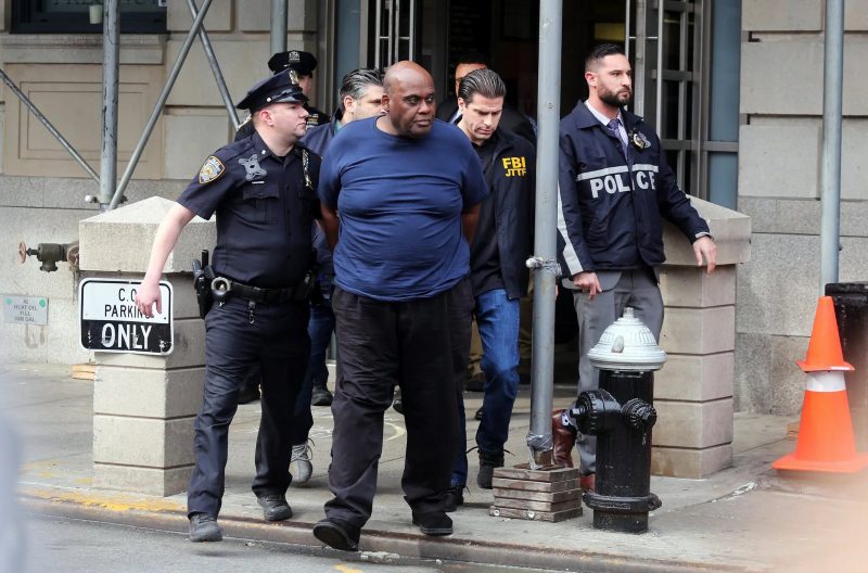 Frank R. James, the suspect in the Brooklyn subway shooting, is seen walking out of the Ninth Precinct in Manhattan’s East Village after his arrest on Wednesday.Credit...Jefferson Siegel for The New York Times