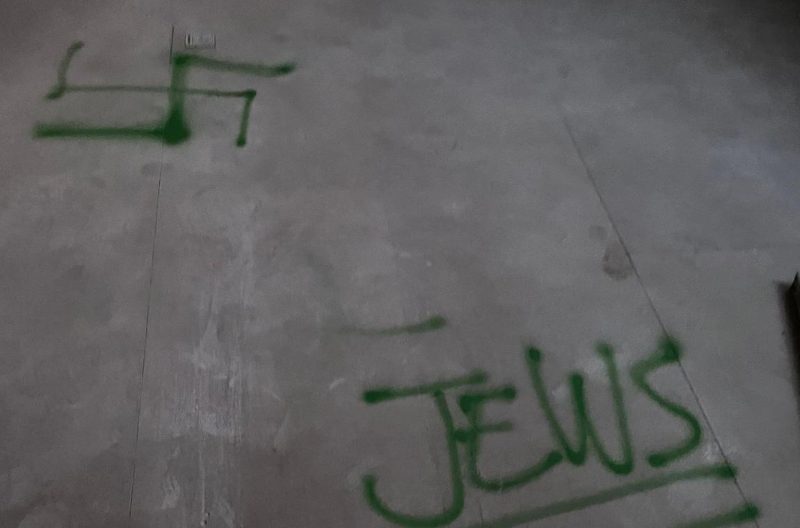 A symbol resembling a swastika was sprayed onto the floor of the house.