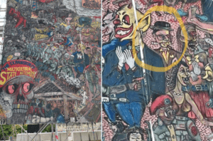 Part of a mural by Indonesian art group Taring Padi on display at the Documenta 15 art festival. On the right, a man is depicted with sidelocks often associated with Orthodox Jews, fangs and bloodshot eyes, and is wearing a black hat with the SS-insignia. (Screen capture/Twitter)