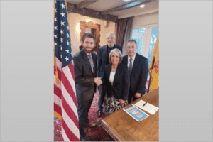 Jordan Cope shakes hands with New Mexico Governor Michelle Lujan Grisham. Standing (left to right) are community leaders Halley Faust and Dr. Todd Goldblum. Credit: StandWithUs