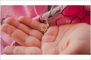 Jewish star necklaces are a signifier of Jewish identity and, some fear, a potential risk during times of antisemitism. (Getty)