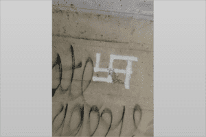 This swastika, along with several racial epithets and antisemitic profanity, was found in a tunnel in Forest City Community Park. A message of love was written over the swastika. COURTESY OF MAX WILLIAMS