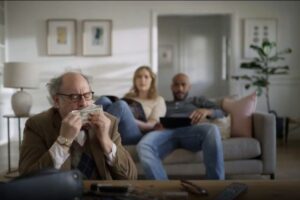 An ad for student debt refinancing company SoFi depicts a man stealing money from a young couple. The company said he was meant to represent a stereotypical professor; one critic said it looked like an antisemitic stereotype. (Screenshot)