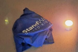 Memorial candle placed next to StandWithUs UK t-shirt after break-in (photo credit: StandWithUs UK)