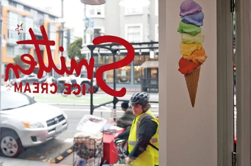 A bicyclist peers through a window at Smitten ice cream in San Francisco, Nov. 22, 2023. The chain's Valencia Street location was vandalized with pro-Palestinian graffiti the month before. (Photo/Aaron Levy-Wolins)